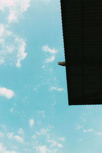 Low angle view of building against cloudy sky