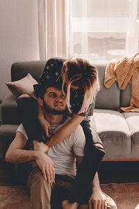 Couple romancing while sitting at home