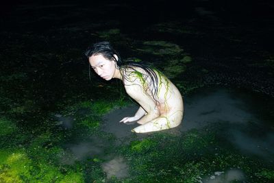 Portrait of young woman in water