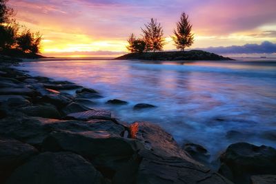 Scenic view of sea against romantic sky at sunset