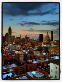 Cityscape against cloudy sky