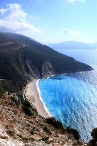 High angle view of sea and mountains against sky