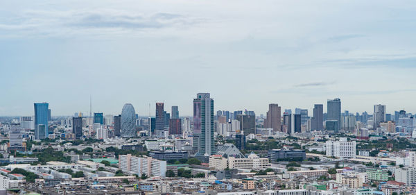 Modern buildings in city against sky