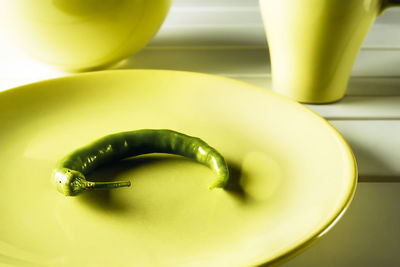 Close-up of green fruit on table