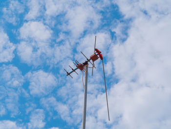 Low angle view of telephone pole against sky