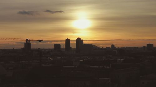 Cityscape against sky during sunset