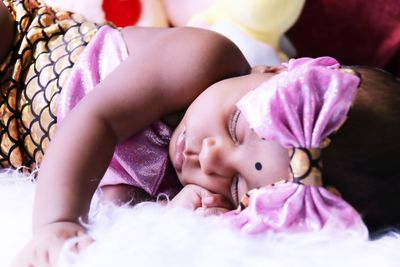 Close-up of baby sleeping on bed