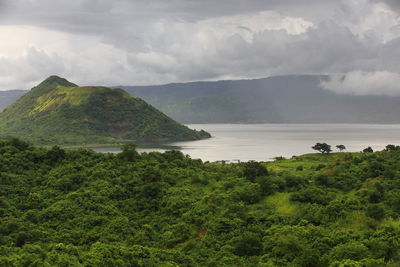 Scenic view of sea and mountains against sky