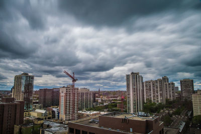 Cityscape against cloudy sky