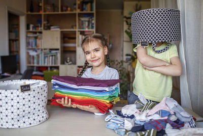 Portrait of cute girl sitting at home