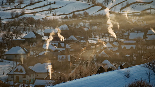 Snow covered houses and buildings in city
