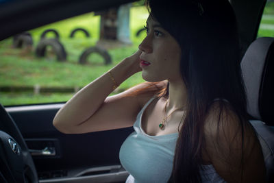 Portrait of woman sitting in car