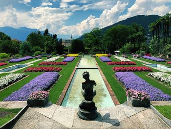 Statues in park against sky