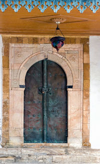 Low angle view of closed door of old building