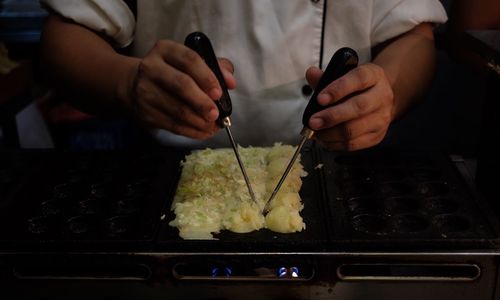 Close-up of man preparing food