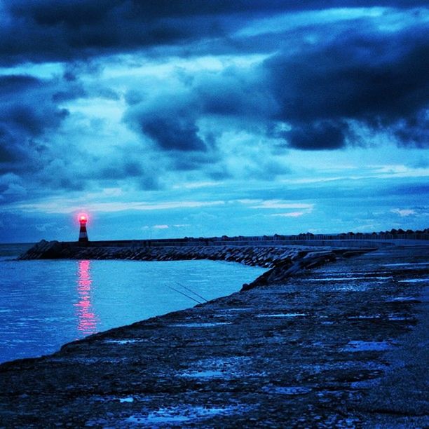 sky, water, cloud - sky, tranquil scene, tranquility, sea, cloudy, scenics, weather, beauty in nature, nature, cloud, dramatic sky, lighthouse, overcast, dusk, horizon over water, idyllic, storm cloud, guidance