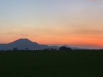 Scenic view of field against sky during sunset