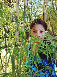 Portrait of woman by bamboo plants