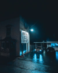 Illuminated road sign at night