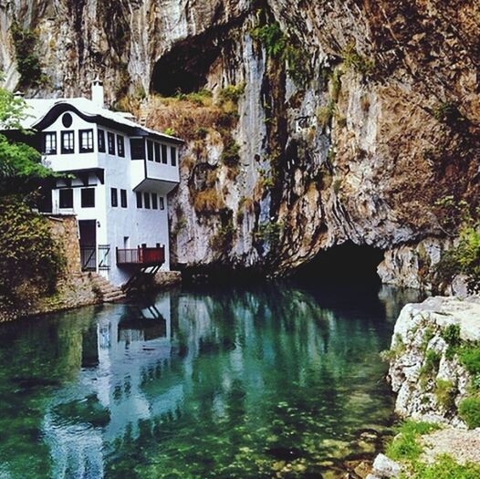 water, architecture, built structure, building exterior, tree, reflection, waterfront, flowing water, rock - object, canal, house, river, nature, waterfall, flowing, day, outdoors, stream, no people, building