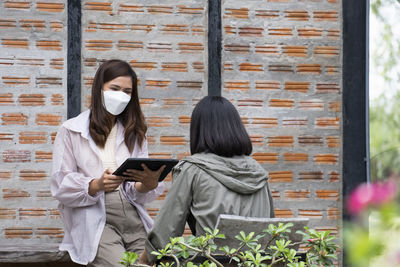 Rear view of woman using mobile phone