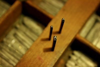 High angle view of letter a on wood at printing press