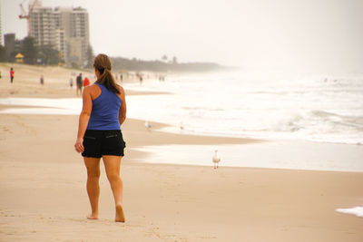 Rear view of woman at beach