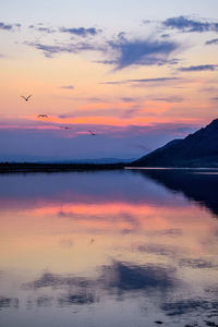 Scenic view of lake against orange sky