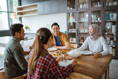 Female friends using smart phone in meeting