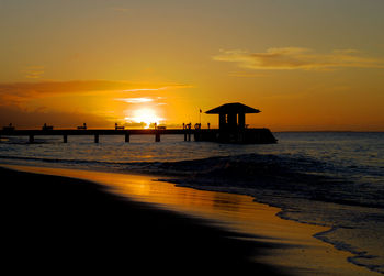 Scenic view of beach against sky during sunset
