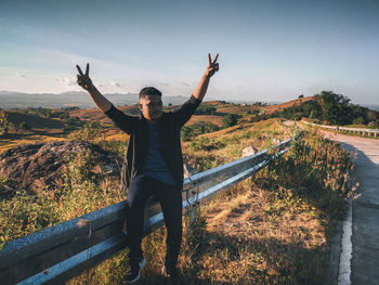 Full length of man standing on mountain against sky