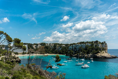 Sailboats in sea against sky