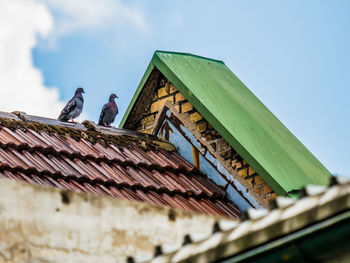 Low angle view of building roof against sky