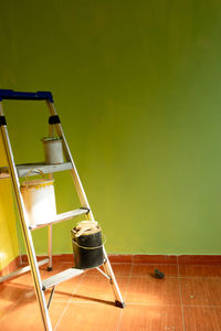 Renovation of a room and wall with fresh paint with text space and ladder with paint buckets