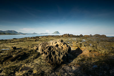 Panoramic view of rocks on land against sky