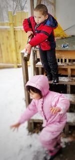 High angle view of girl standing against pink during winter