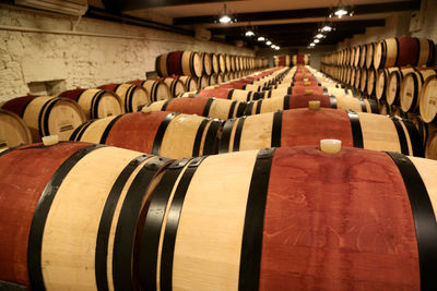 Row of wine barrels in building