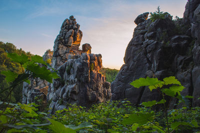 Low angle view of rock formations against sky