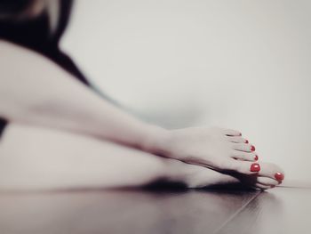 Low section of woman lying on flooring at home