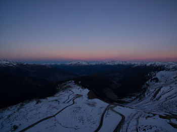 Scenic view of snow covered mountains against sky during sunset