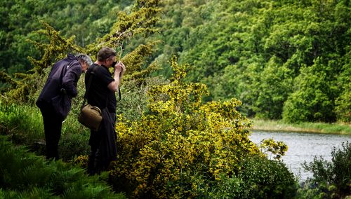 Rear view of couple on plants against trees