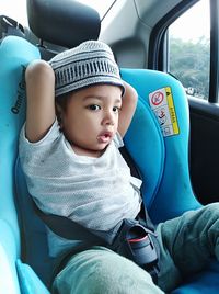 Cute girl sitting in car