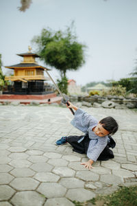 Full length of boy on footpath