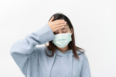 Portrait of woman standing against white background