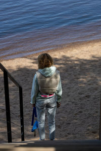 Rear view of man standing at beach