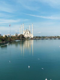 View of factory at waterfront against sky