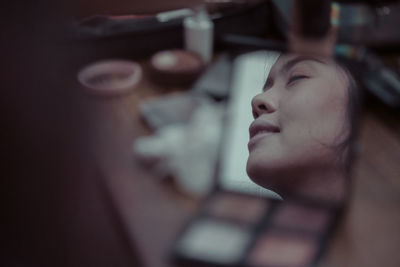 Close-up portrait of young woman with eyes closed