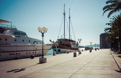 Yacht and tall ship moored at promenade