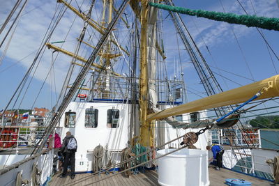 Boats moored at harbor against sky