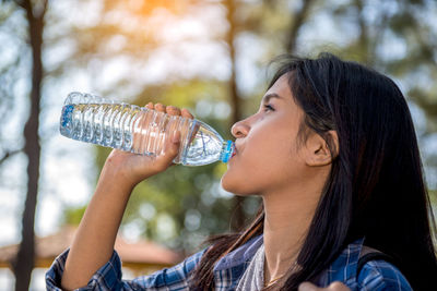 Close-up of woman drinking water from bottle